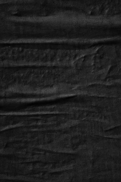 istock Dark black blank paper backgrounds creased crumpled surface old torn ripped posters grunge textures placard 1129863335