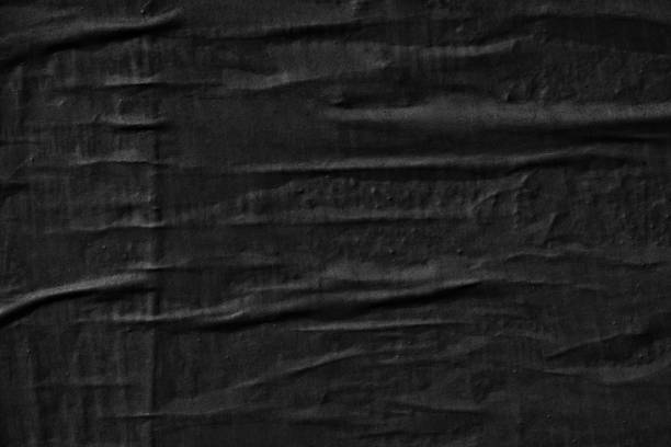 istock Dark black blank paper backgrounds creased crumpled surface old torn ripped posters grunge textures placard 1129863412