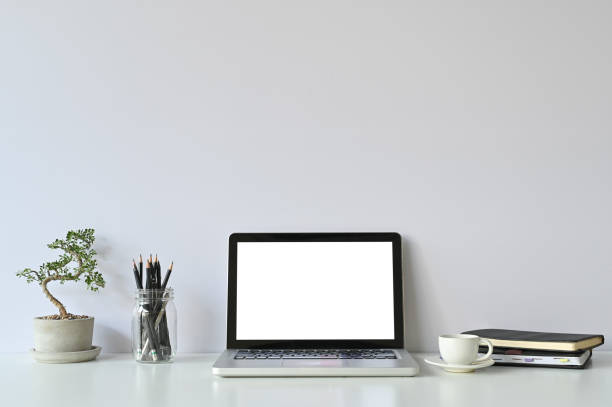 istock Mockup laptop computer and office supplies and small bonsai on workspace. 1129863614