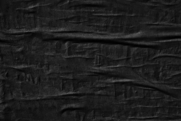 istock Dark black blank paper backgrounds creased crumpled surface old torn ripped posters grunge textures placard 1129863675