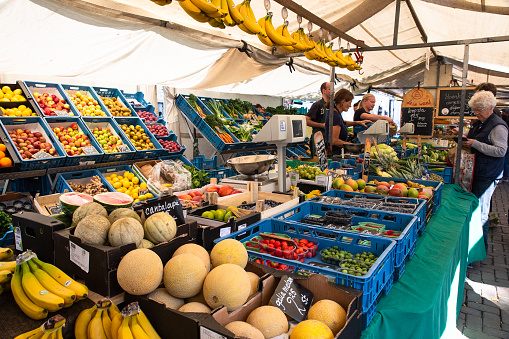Amsterdam, Netherlands - September 2, 2018:  View from organic Farmers Market in Amsterdam with a variety of produce and people visible