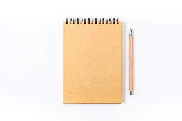 istock Brown spiral notebook isolated on white background.top view 1129864578
