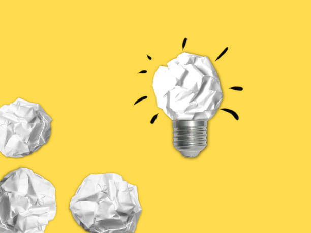 istock Idea light bulb success inspiration crumpled paper isolated background 1129866909