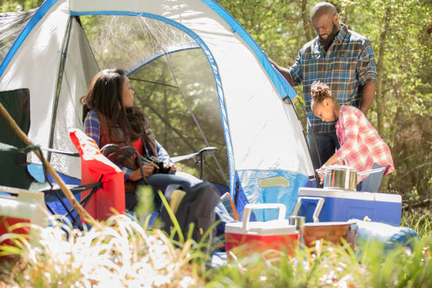 istock Family on summer or autumn vacation camping in forest. 1129867498