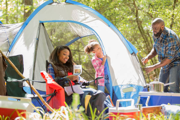 istock Family on summer or autumn vacation camping in forest. 1129868077
