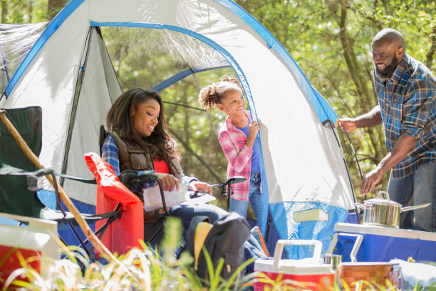 istock Family on summer or autumn vacation camping in forest. 1129868089