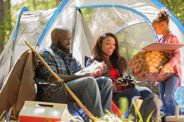 istock Family on summer or autumn vacation camping in forest. 1129868096