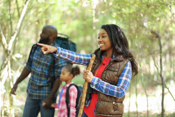 istock Family on summer or autumn vacation camping in forest. 1129868215