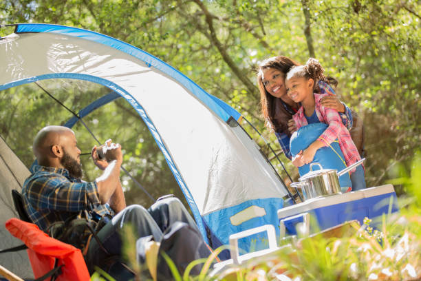istock Family on summer or autumn vacation camping in forest. 1129868241