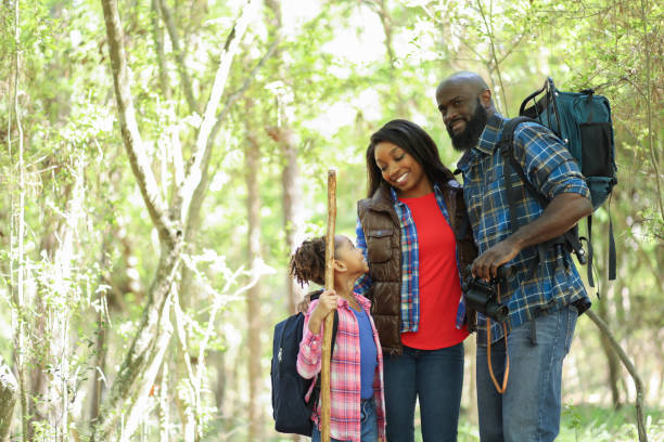 istock Family on summer or autumn vacation camping in forest. 1129868256