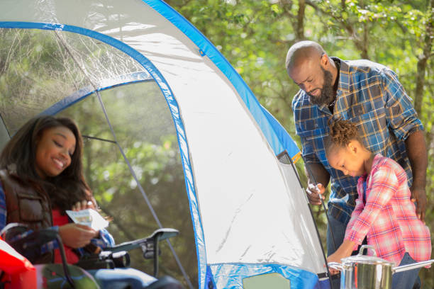 istock Family on summer or autumn vacation camping in forest. 1129868264