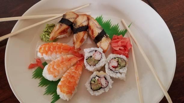 istock Sushi Sampler on a Large White Plate, with Chopsticks, Top View 1129868566