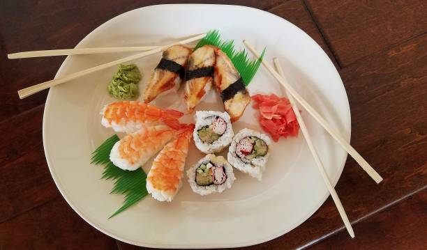 istock Japanese Sushi with Chopsticks, Top View, Served on a Large White Plate 1129868574