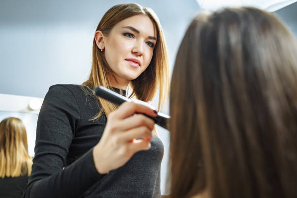 istock Makeup artist creating beautiful makeup for brunette model . Beauty concept. 1129869448