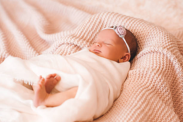 ベッドで赤ちゃんの女の子 - baby people headband portrait ストックフォトと画像