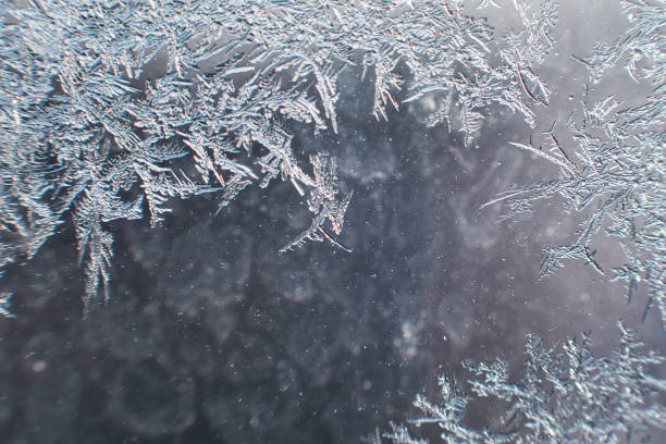 istock snow pattern on the glass from frost 1129870830