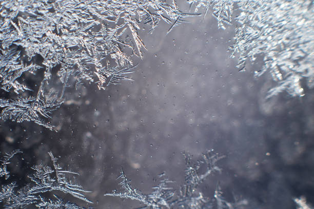 istock snow pattern on the glass from frost 1129870922