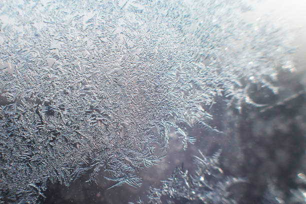 istock snow pattern on the glass from frost 1129871536