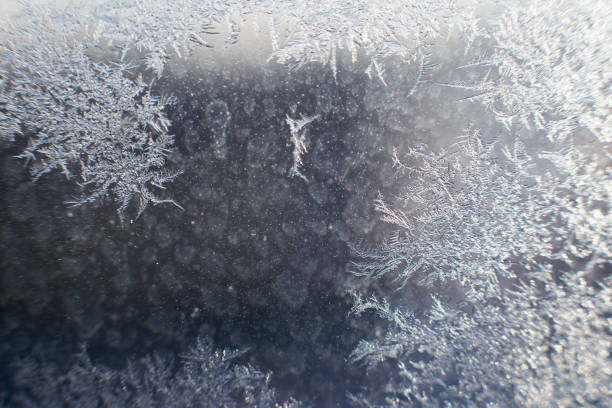 istock snow pattern on the glass from frost 1129871577