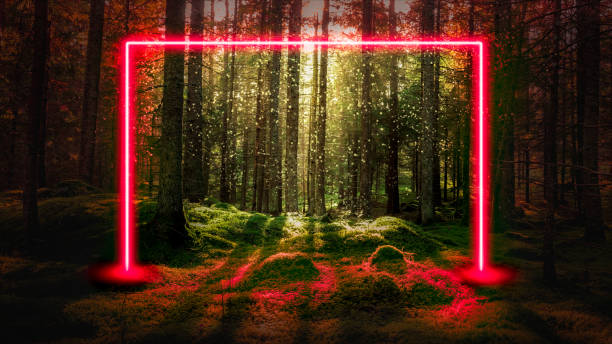 istock Red fluorescent neon laser lights in green magical forest landscape. 1129871974