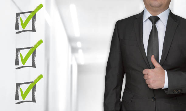 istock Checklist concept and businessman with thumbs up 1129872910