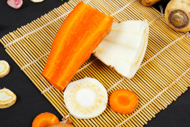istock parsnip, carrots, onion, garlic, vegetables, on a black background 1129873204