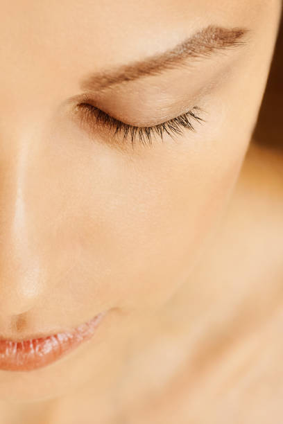 istock Female face with closed eyes, perfect skin, without make-up 1129874675