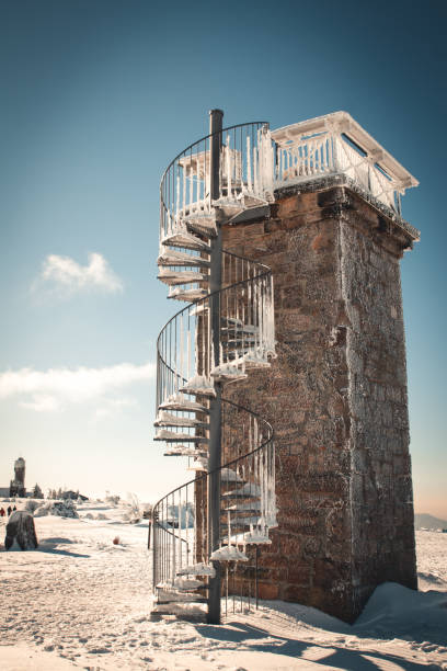 A narrow spiral staircase with a pole in the middle as a handrail leads to the top of the Capelinhos lighthouse on Faial Island in the Azores.