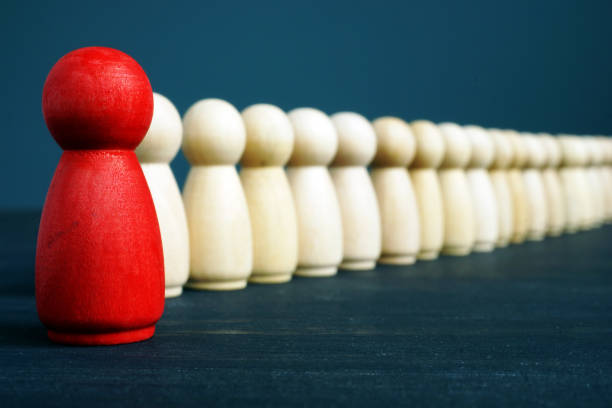 istock Red figurine Stand out from the crowd. Difference and unique concept. 1129877219