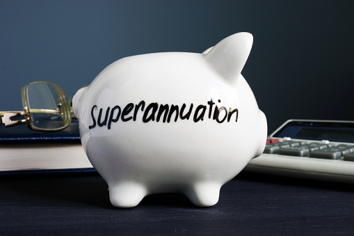 Superannuation written on a white piggy bank.