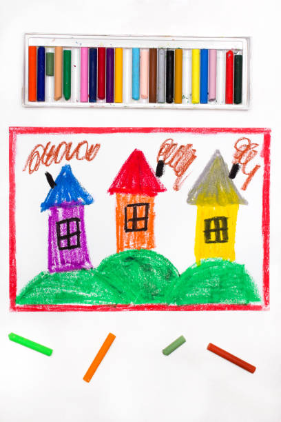 istock Colorful drawing: village with small houses on hills 1129884734