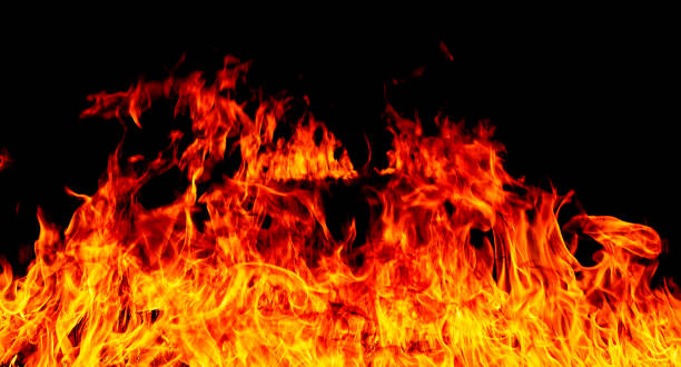 istock Firestorm texture on black background, shot of flying fire sparks 1129884891
