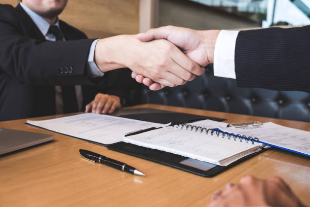 istock Successful job interview with boss and employee shaking hands after negotiation or interview, career and placement concept 1129885209