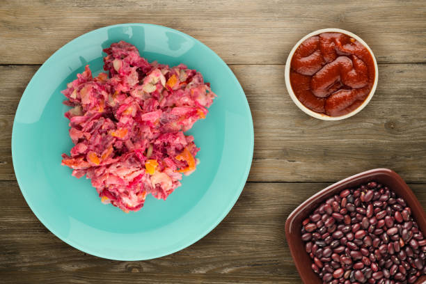 istock herring under a fur coat on a plate. Herring under a fur coat on a wooden background. herring, beetroot, carrot, mayonnaise and onion salad 1129886045