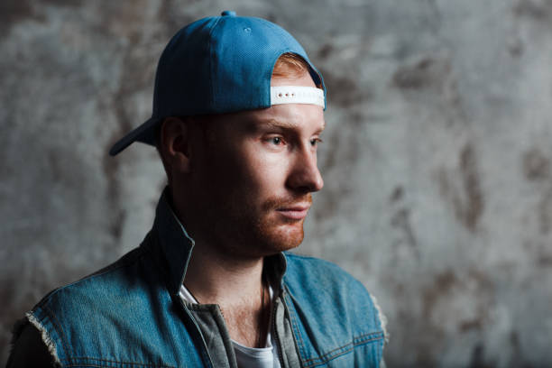 istock Male in a baseball cap and a denim jacket 1129887098
