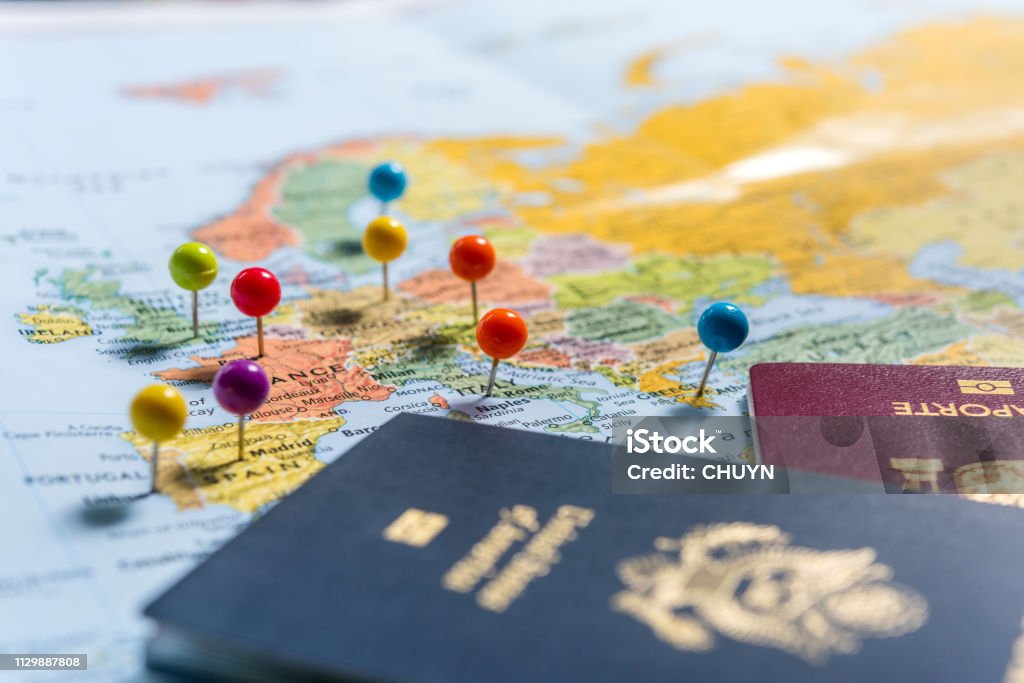 Planning Holidays Maps with pins and passports, planning the holidays. Passport Stock Photo
