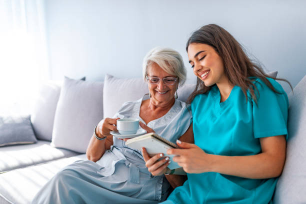 istock Happy patient is holding caregiver for a hand while spending time together. 1129892251