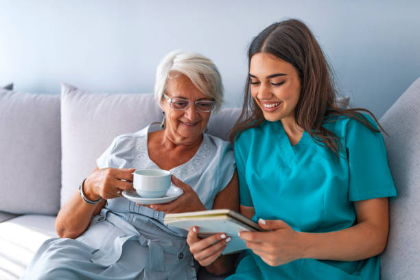 istock Young nurse spending time with happy elder patient in nursing home 1129892329