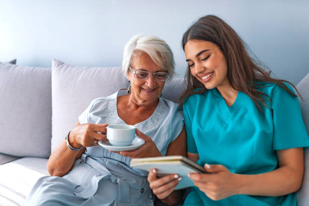 istock Young nurse spending time with happy elder patient in nursing home 1129892330