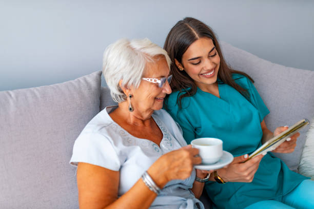 istock Young caring lovely caregiver and happy ward 1129892530