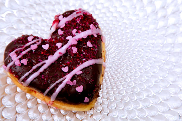 istock Heart shape Valentine doughnut on a fancy plate 1129892779