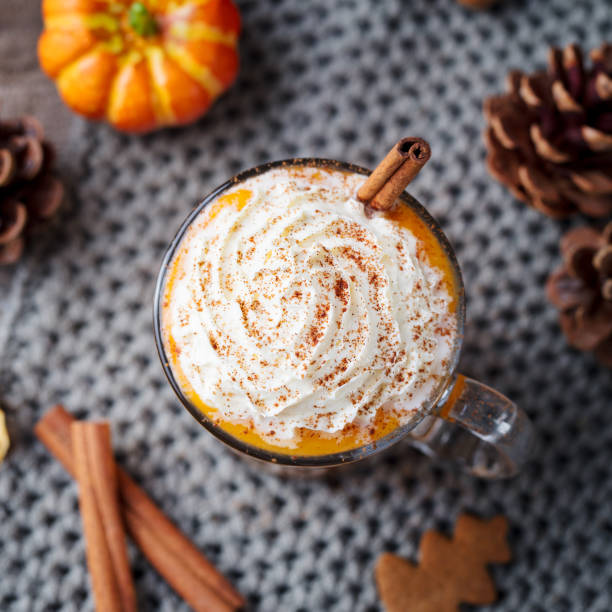 istock Pumpkin latte with spices and whipped cream. Grey background. Close up. Top view. 1129893979