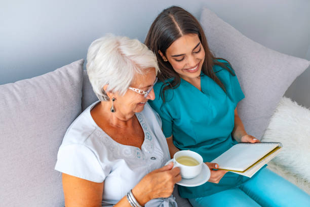 istock Happy patient is holding caregiver for a hand while spending time together 1129894004