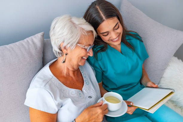 istock Happy patient is holding caregiver for a hand while spending time together 1129894008