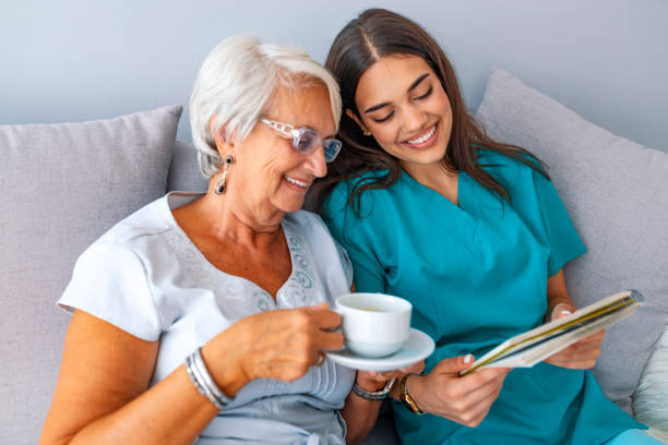 istock Young nurse spending time with happy elder patient in nursing home. 1129894190