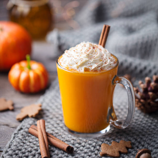 istock Pumpkin latte with spices and whipped cream. Grey background. Close up. 1129894269