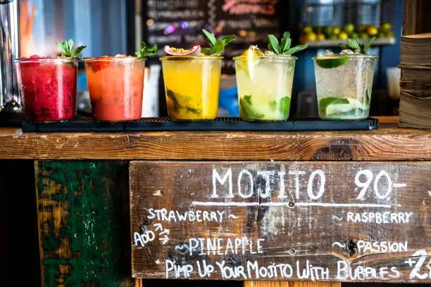 Photo of Tropical colorful mojito at a wooden bar