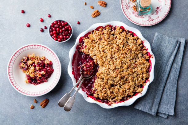 istock Cherry, red berry crumble in baking dish. Grey stone background. Top view. 1129894424