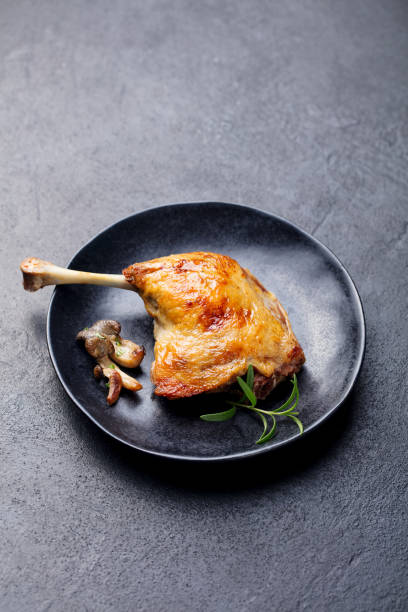 istock Duck legs confit with mushroom sauce . Restaurant serving. Copy space. 1129895778