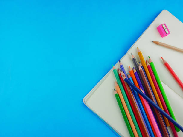 istock Flat lay,top view stationery including color pencils and notebook with copy space 1129897130